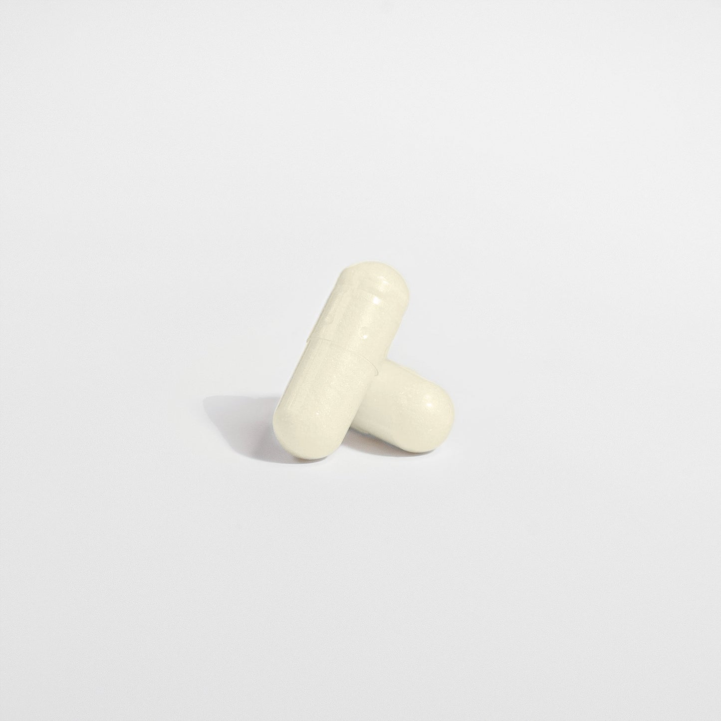 Two capsules sit on a light gray background
