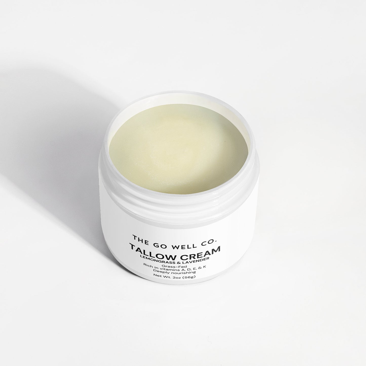 White jar of Tallow Cream from The Go Well Co. on a white background