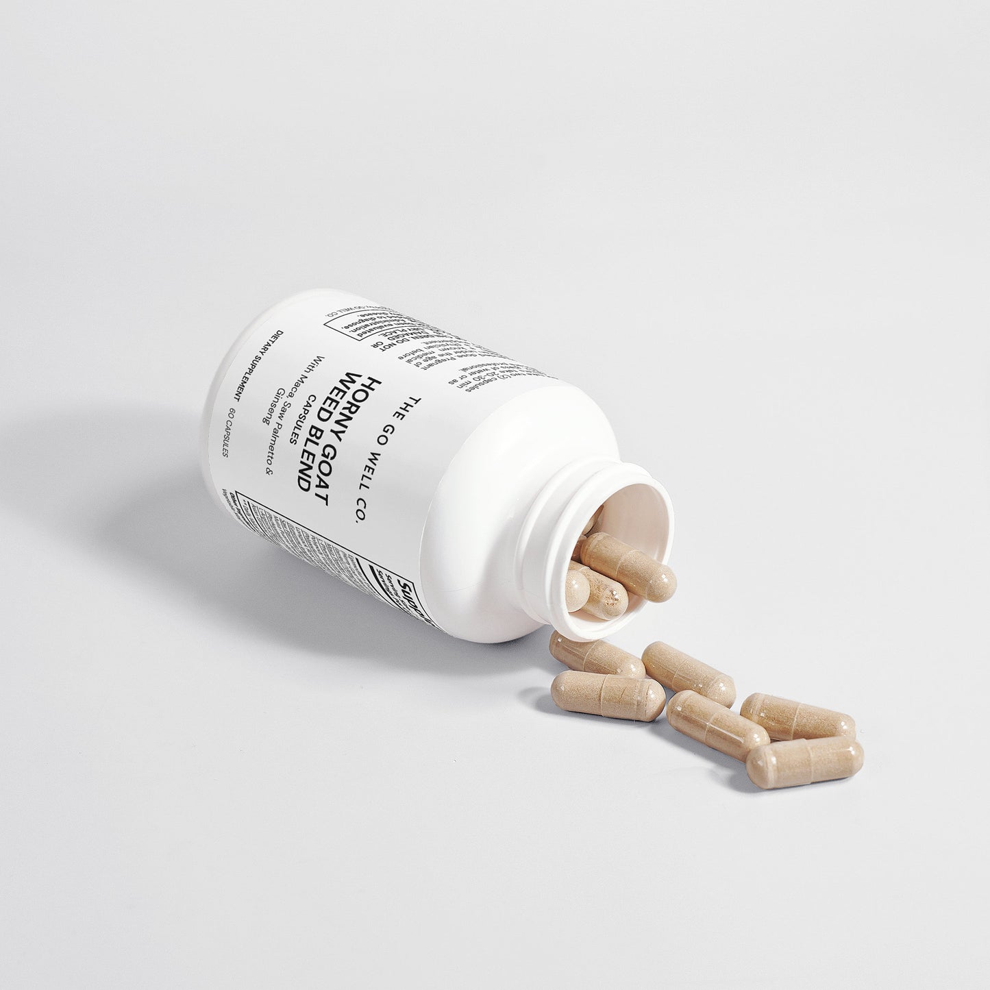 White supplement bottle with capsules on a light gray background