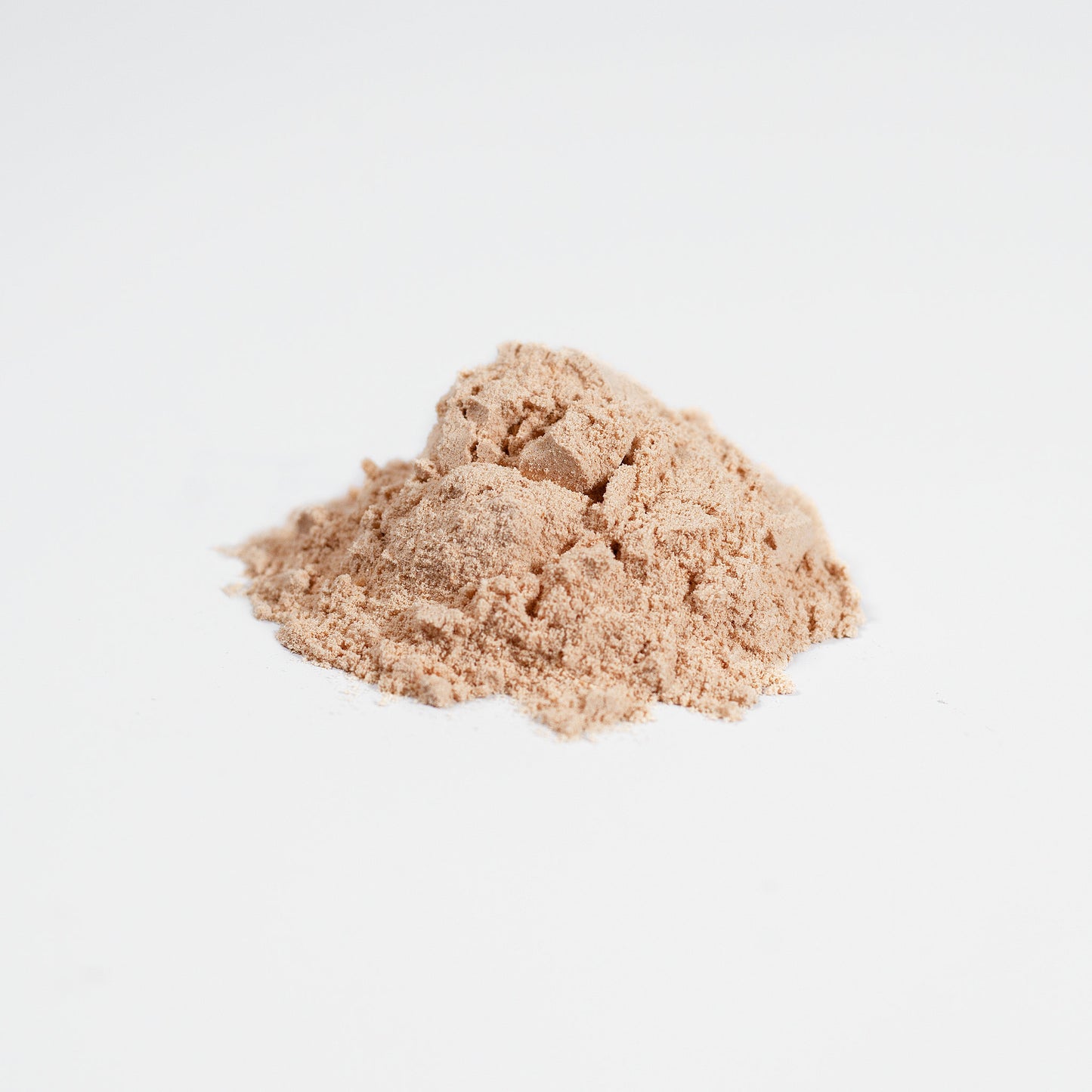 Two mounds of beige powder on a white background