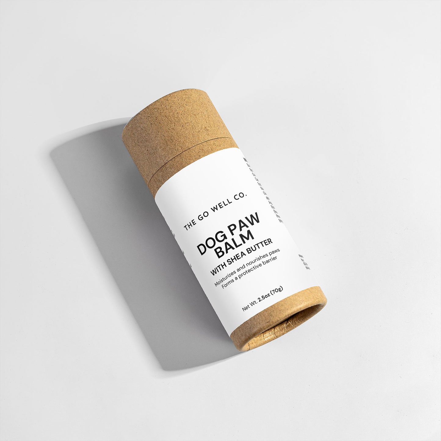Dog paw balm in a brown cardboard tube on a light gray background