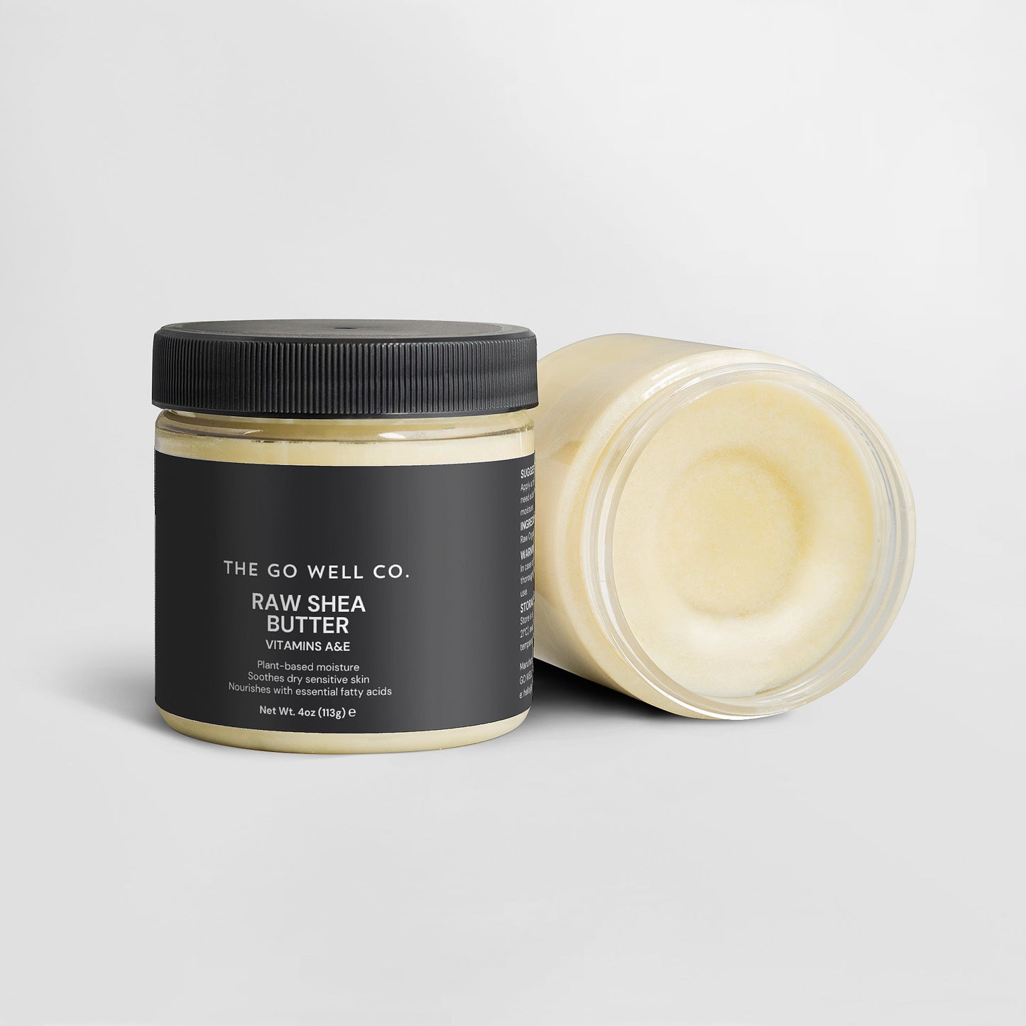 Jar of raw shea butter from The Go Well Co. on a light gray background