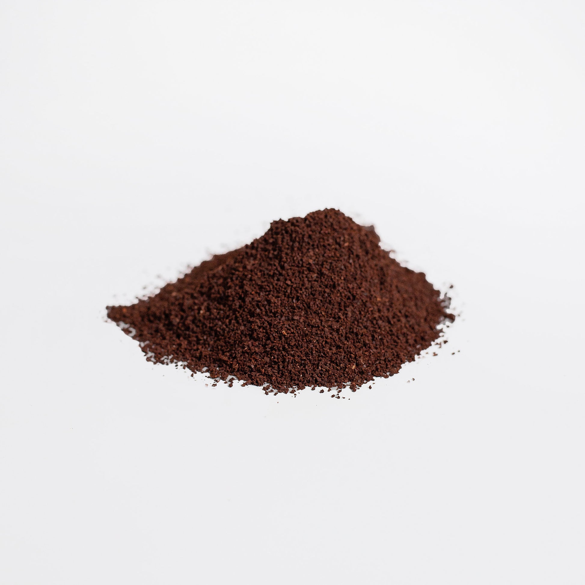 Pile of ground coffee on a white background