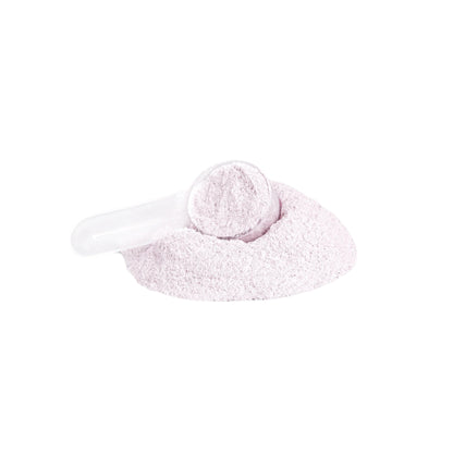 White scoop with pink powder on a light gray background