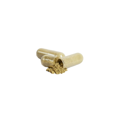 Open capsule with powder inside on a light gray background