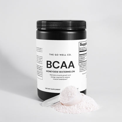 BCAA supplement container with a scoop of powder on a light gray background