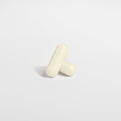 Two capsules sit on a light gray background
