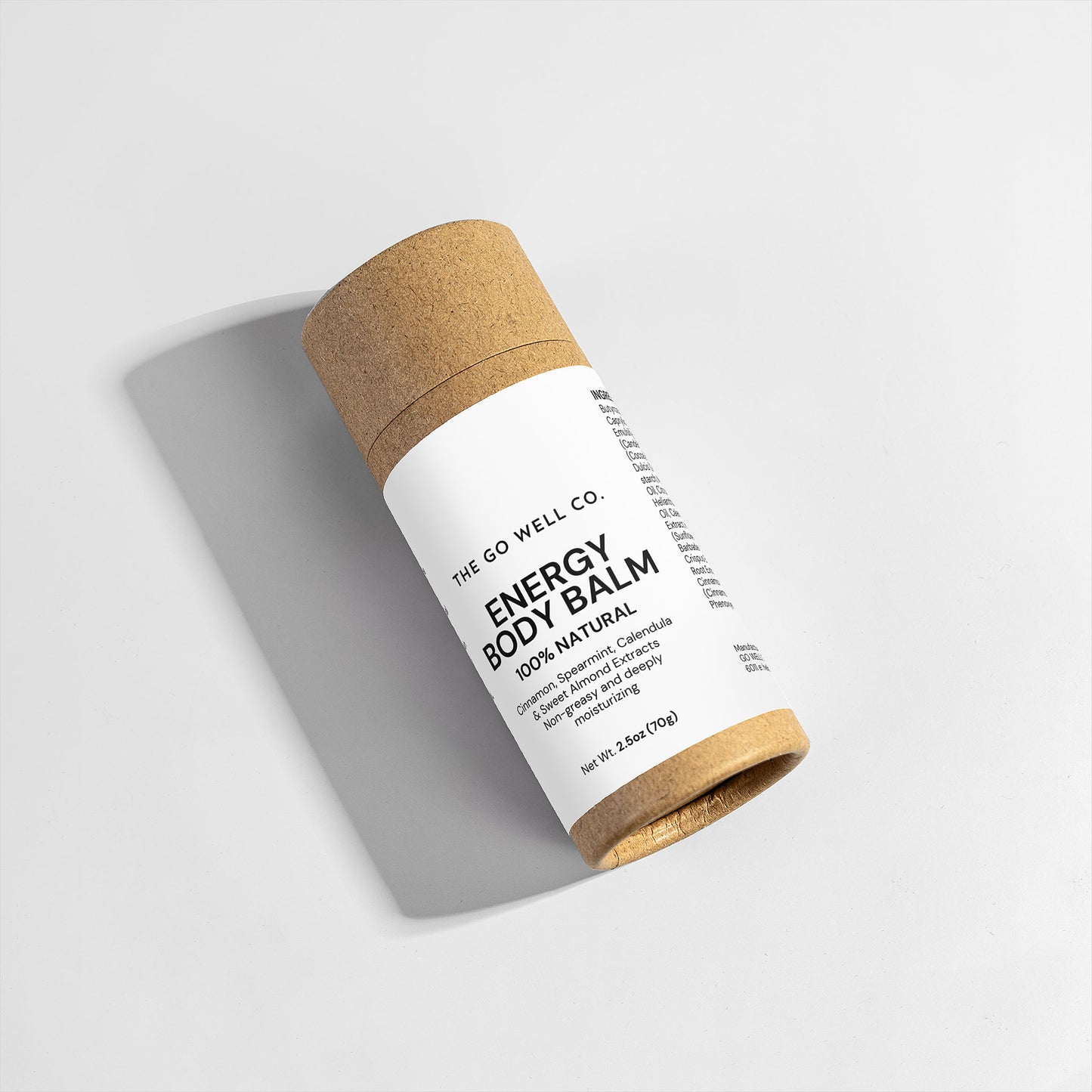 Energy body balm in a brown cardboard tube on a light gray background