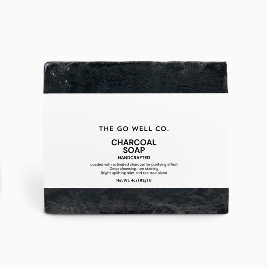 Black soap bar with 'The Go Well Co.' branding on a white background