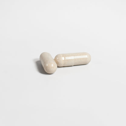 Two beige capsules on a light gray background